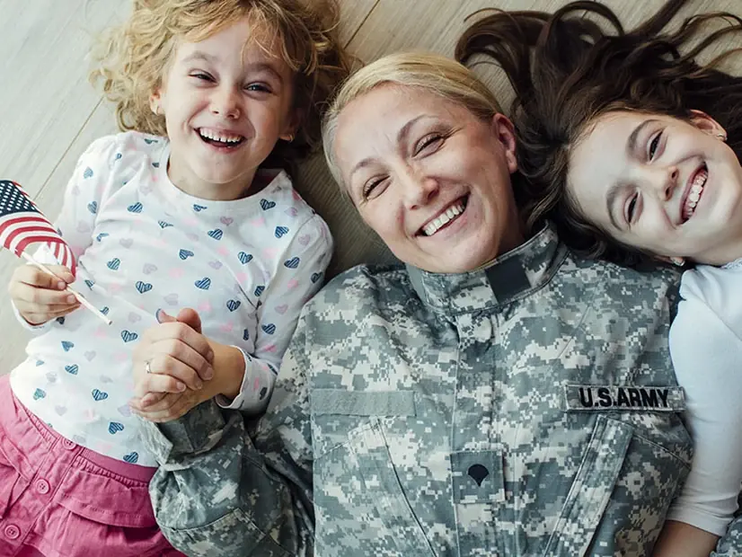 A servicemember at home with her two daughters.